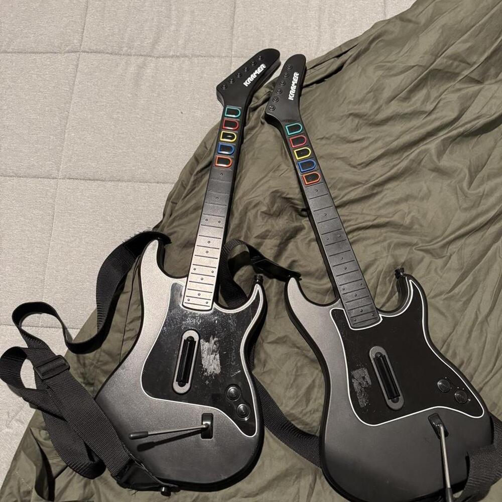 Guitar Hero 5 guitar controllers with colorful lettering on the neck